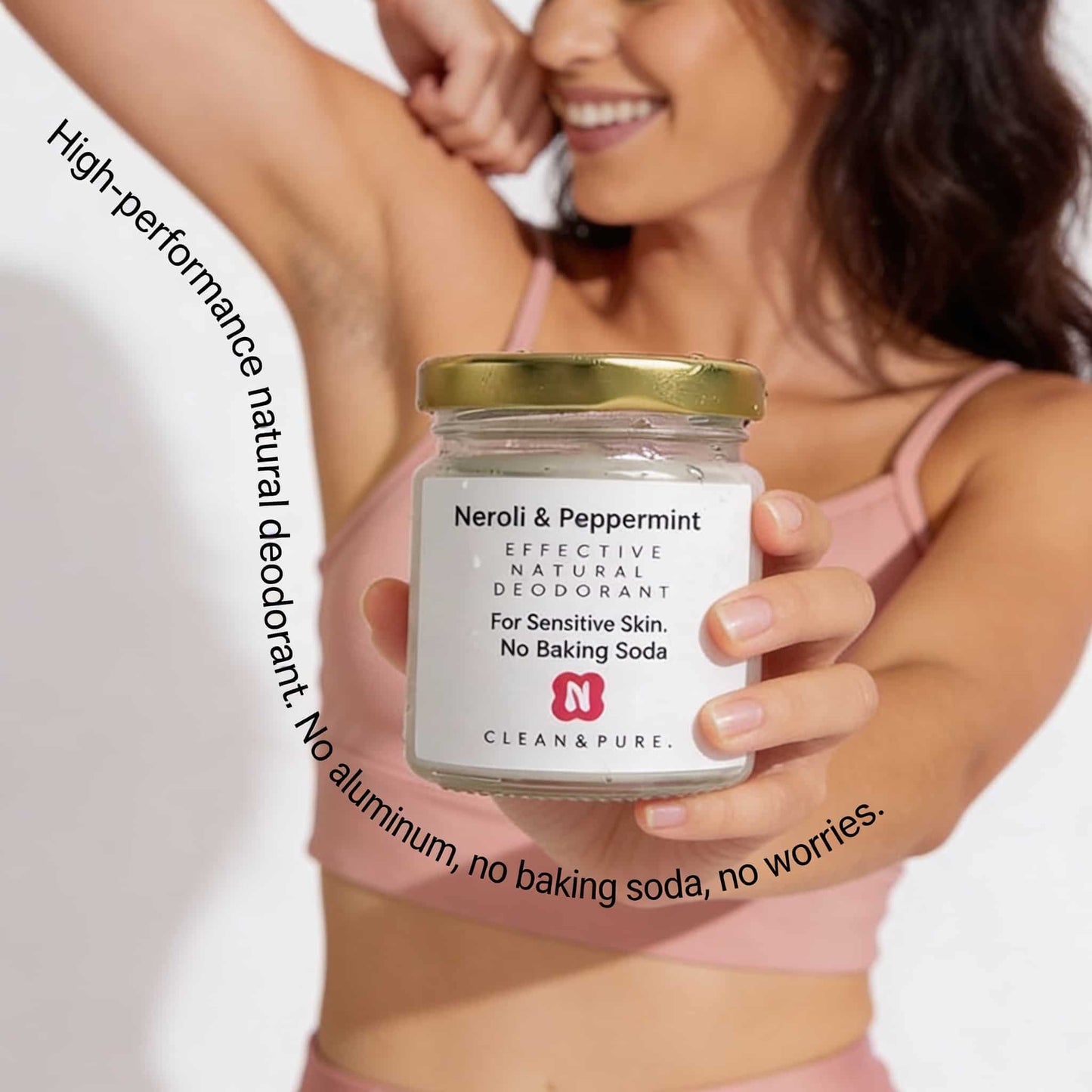 Active woman tests underarm freshness with natural deodorant for sensitive skin Baking Soda Free