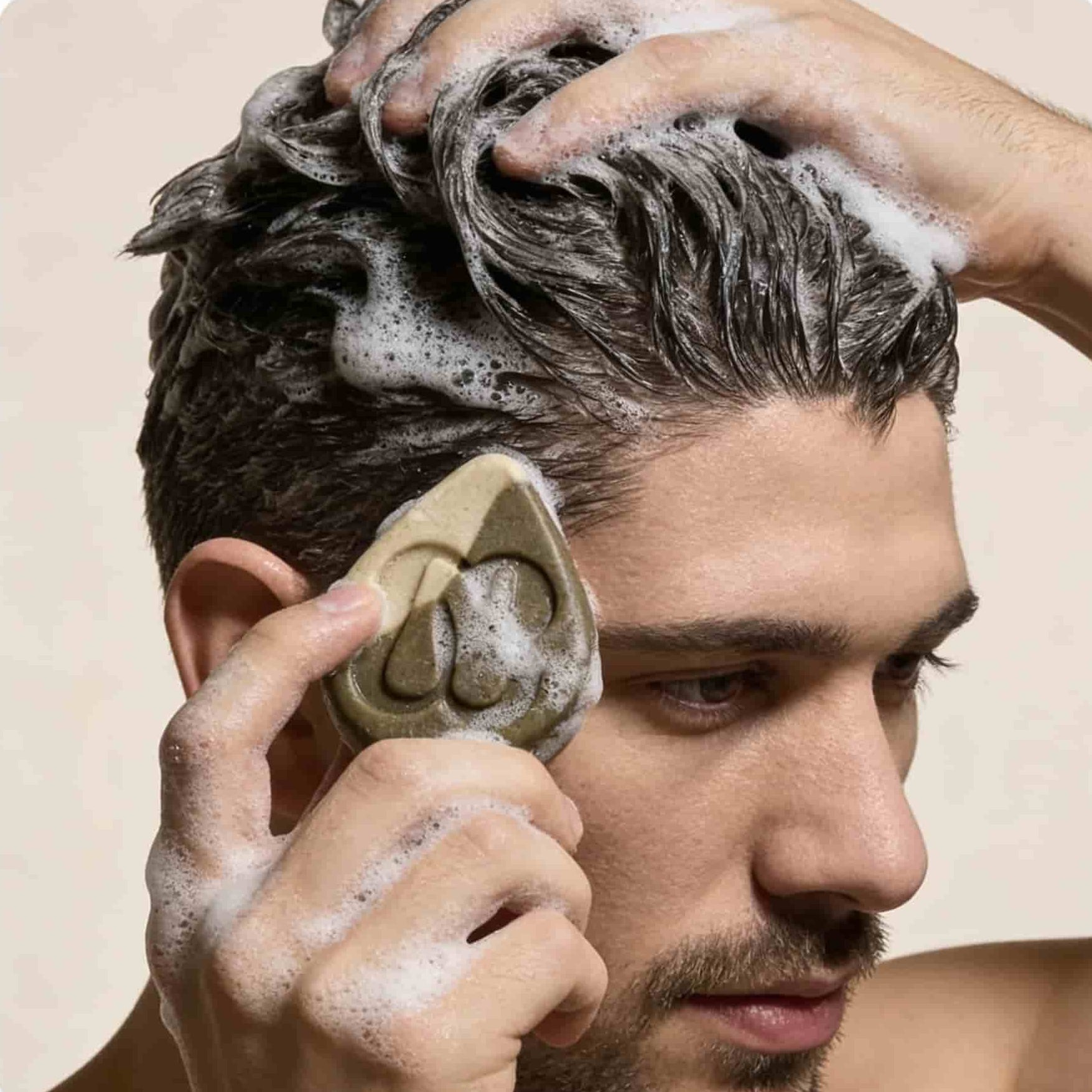 Man in the shower using Alpine Reset NZ glacial clay shampoo bar for hair volume and scalp clarity